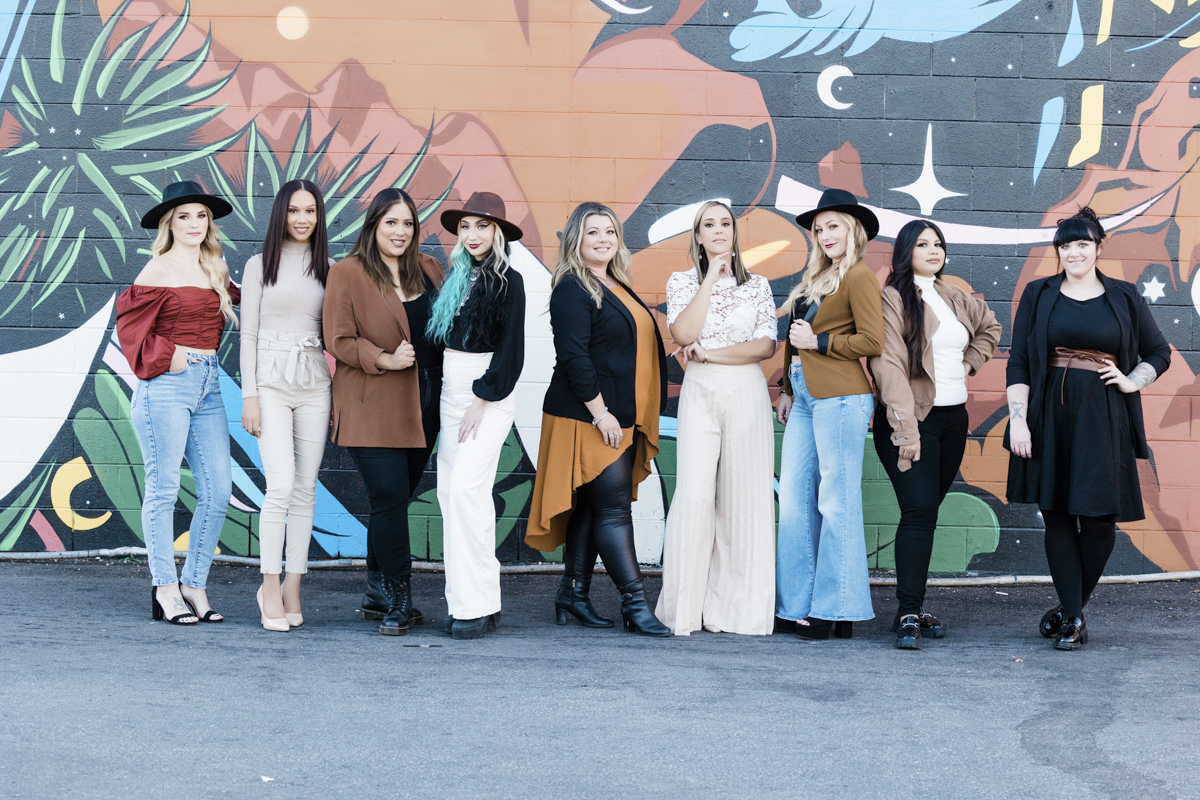 9 women standing in front of grafitti wall in downtown Las Vegas.