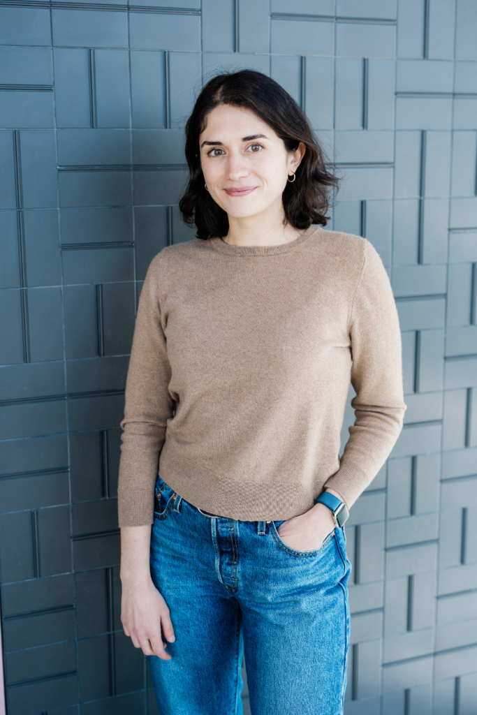A woman poses for a headshot. Small business owners can use this type of photo on their social media feed to boost their business.